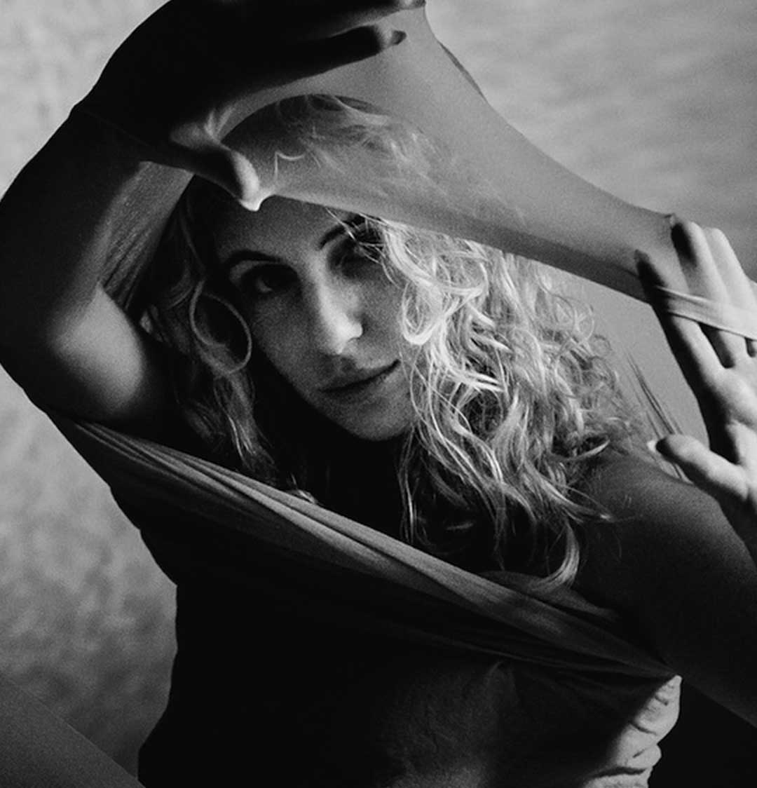 A close, black-and-white study of hands and skin, from Karolina Prom’s body of work